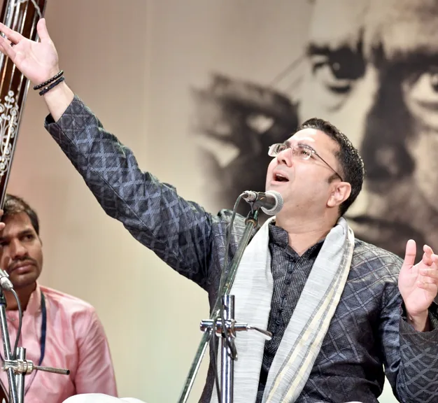 Sandeep performing with arm raised