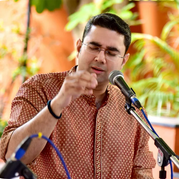 Sandeep singing at a microphone